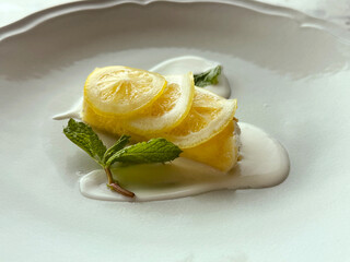 Pancake with Lemon Mousse Served with Vanilla Sauce, Fresh Mint, and Lemon Slices. Homemade Dessert Concept. Handmade Phone Photo, Selective Focus, Not AI