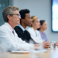 Fototapeta premium Diverse team of medical professionals attending a meeting, seminar or conference. Focus on collaboration, learning, teamwork, and healthcare industry. Modern, clean aesthetic.