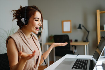 Woman wearing headset communicating during online video call
