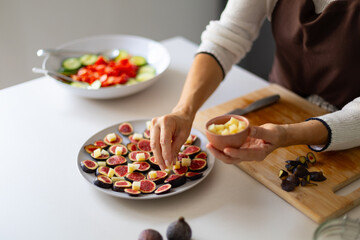 Preparing fig and cheese appetizer for healthy snack
