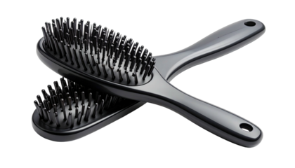 Two shiny black hair brushes, one resting atop the other, on a dark backdrop