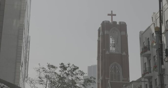 Towering Church with Cross Set Against Clear Sky in Urban Location Shanghai, China