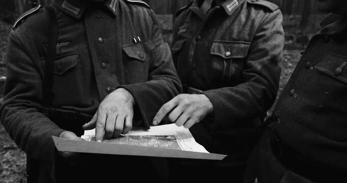 Historical Re-enactment Black And White Video. World War II German wehrmacht Soldier officer Commander Soldiers Of World War II Briefs, Showing Direction Of A Attack On Map