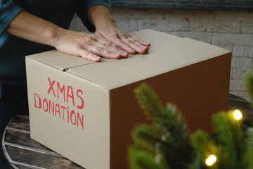 Christmas donations. Volunteer donating Xmas gifts. 