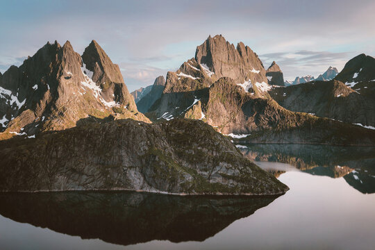 Fototapeta Lofoten islands in Norway sunset landscape Solbjornvatnet lake and mountains nature water reflection travel Scandinavian beautiful destinations, natural landmarks summer season tranquil scenery