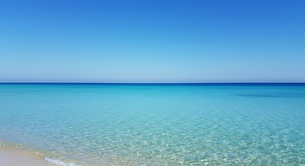 Obraz premium Crystal Clear Azure Waters and Sandy Beach Under a Bright Blue Sky
