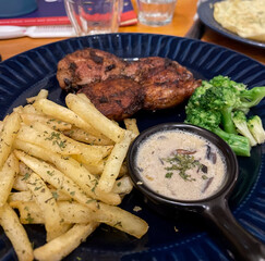 grilled chicken steak and potato chips french fries with broccoli and mushroom creamy sauce