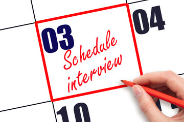 3 rd day of the month. Hand writing Schedule interview reminder and drawing red frame on calendar...