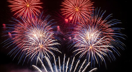 Vibrant fireworks display illuminating the night sky with bursts of color and light trails forming patterns created with generated ai