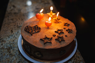 Delicious chocolate cake with candles and decorations for a celebration