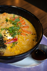 Photo of freshly cooked Japanese Ramen.
Japanese Ramen with chicken, Mushrooms, Eggs and bok choy cabbage in a bowl 
