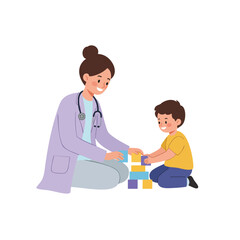 a pediatrician sitting on the floor playing blocks with a little boy, doctor wearing a lilac lab coat and light gray pants, both smiling.