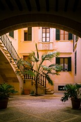 1.Palm-lined Inner Courtyard: A classic inner courtyard with palm trees, stone steps, and architectural arches.