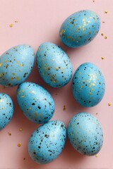 Fototapeta premium Light blue speckled eggs on a pink background