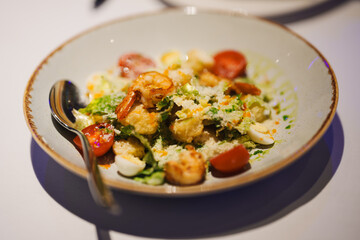 Fresh shrimp salad with cherry tomatoes and herbs served in a bowl