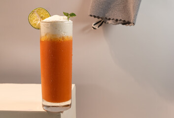 Homemade fresh ice cold orange with milk cream on top