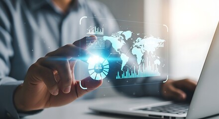 Futuristic holographic globe interface interacting with a laptop and hand