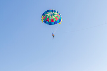 Shot of the person doing person doing parasailing activity. Outdoors