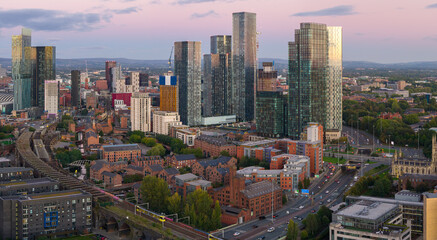 Obraz premium Aerial view of Manchester skyline and Mancunian Way at dusk with Deansgate Square and Castlefield area below.