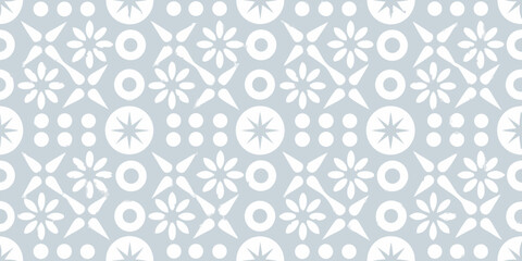 Seamless geometric pattern with white stylized flowers and starbursts on a pale blue background