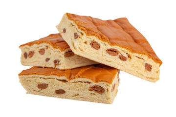 Stacked nougat pieces showcase a textured, golden-brown surface with scattered, embedded inclusions.