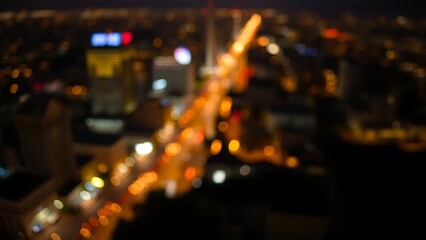 A nighttime cityscape with warm lights and a dreamy bokeh effect.