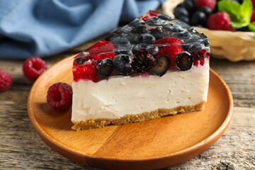 Piece of delicious cheesecake with berries on wooden table, closeup