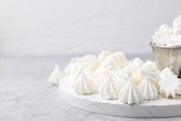 Delicious meringue cookies on grey table, closeup. Space for text