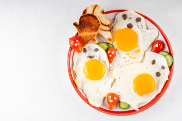 Halloween food, ghost shaped fried eggs, toasts and vegetable salad. Creative homemade lunch or breakfast for Halloween holiday morning