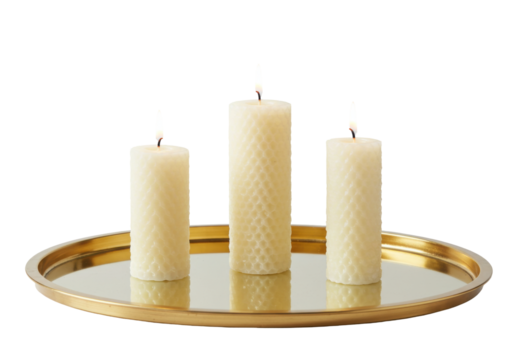 Isolated golden tray centerpiece with three beeswax candles on a reflective tray