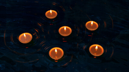 Traditional Clay Diyas Floating on Water