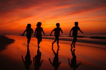 Silhouette of children running along a beach at sunset. The sky is filled with vibrant hues of orange and red, casting reflections on the wet sand.