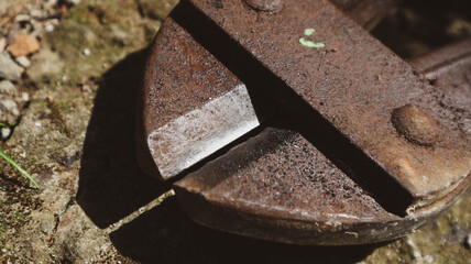 Close-up of rusty bolt cutter on rough surface. Industrial cutting tool ideal for themes of...