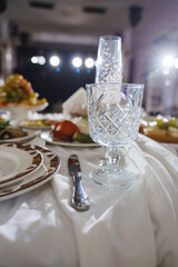 Elegant dining setup at a special event with sparkling lights in background