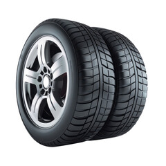 Stacked car tires with silver rims against a in studio lighting