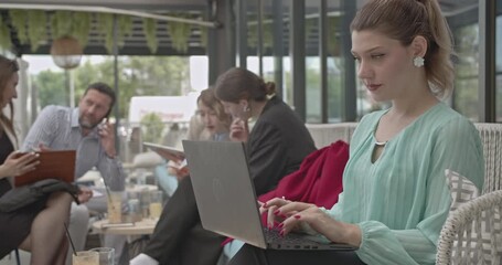 A group of diverse professionals collaborates and works productively during an informal team meeting outdoors. - Powered by Adobe