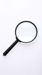 Close-up of a black magnifying glass on a white background.  The lens is round and clear, with a dark black frame.  A dark black handle extends from the lens