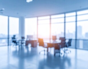 Blurry modern office interior, sunlight through large windows