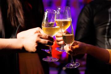 A vibrant festival atmosphere with people drinking and making a toast.