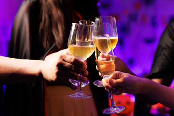 A vibrant festival atmosphere with people drinking and making a toast.