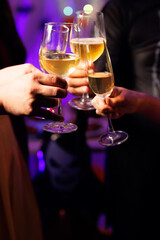 A vibrant festival atmosphere with people drinking and making a toast.