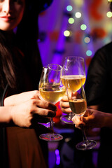 A vibrant festival atmosphere with people drinking and making a toast.