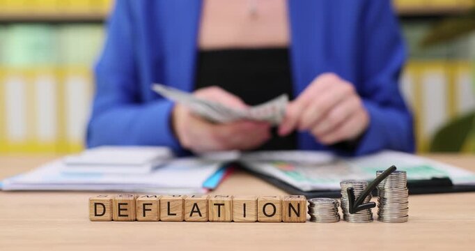 Counting cash while discussing the impact of deflation on personal finances and savings strategies in a cozy cafe setting
