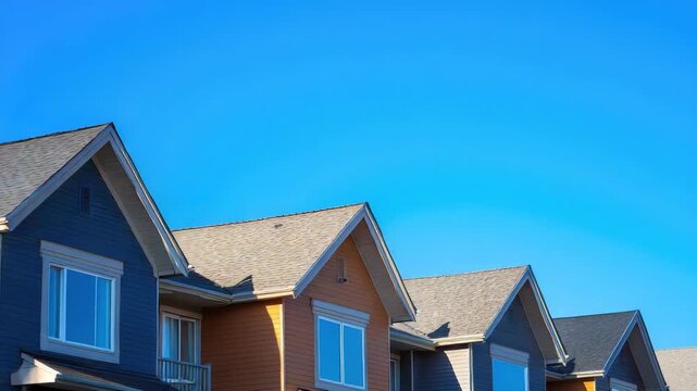 Row of modern suburban houses with clear blue sky in background