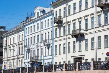 row of traditional, tall European residential buildings. Classical detailing, ornate iron balconies. For themes related to European travel, classic architecture, or city life photography