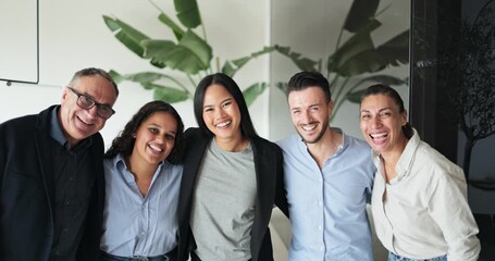 Multi generational business people smiling on camera inside company office - Multiracial colleagues having fun together - Job, relationship and corporate concept 