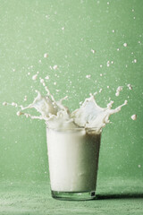 Vegan Minimalism Sustainability Concept, Vegan healthy minimalism lifestyle with plant based milk splash sustainability concept glass green