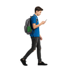 Fototapeta premium Focused young man walks with backpack looking at mobile phone isolated transparent background