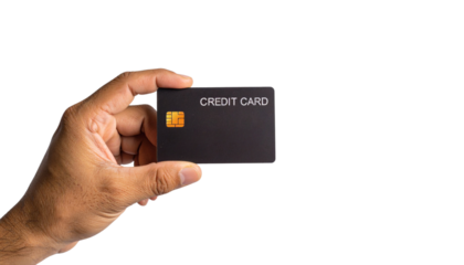 Concept of modern finance and cashless payment, a person's hand presents a black credit card isolated on a white studio background