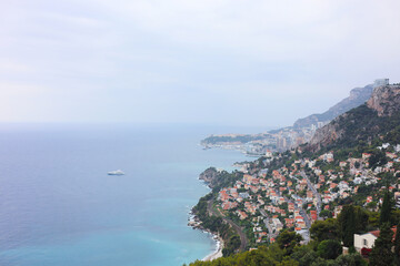 Obraz premium Aerial view of ship on sea and beautiful coastal city